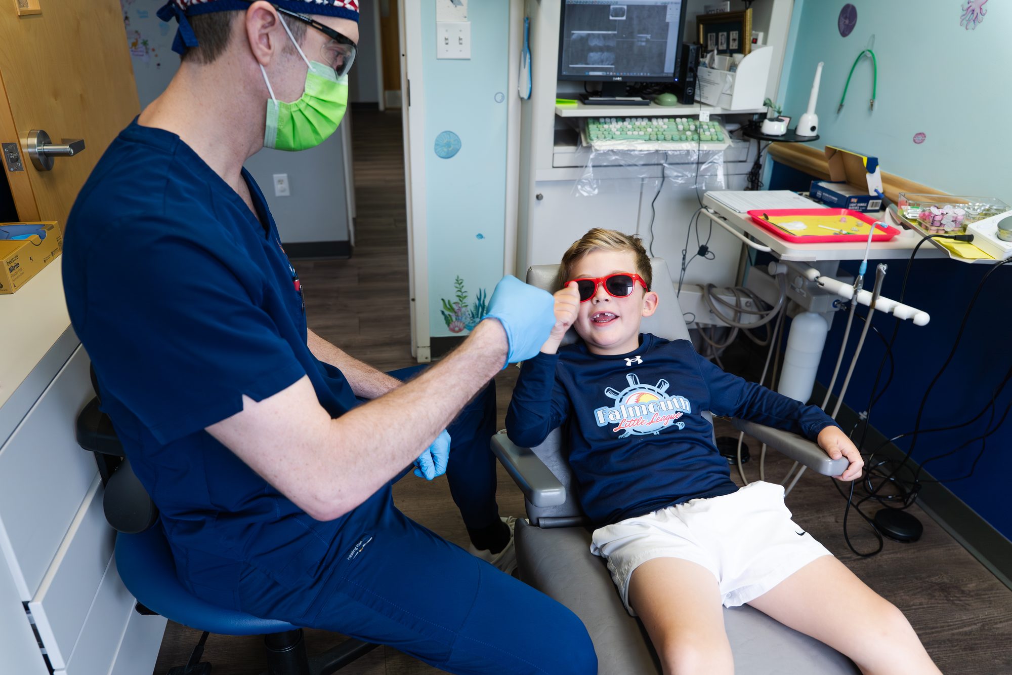 Falmouth Pediatric Dentistry ocean-themed waiting area with navy anchor rug and coastal decor in Falmouth, ME