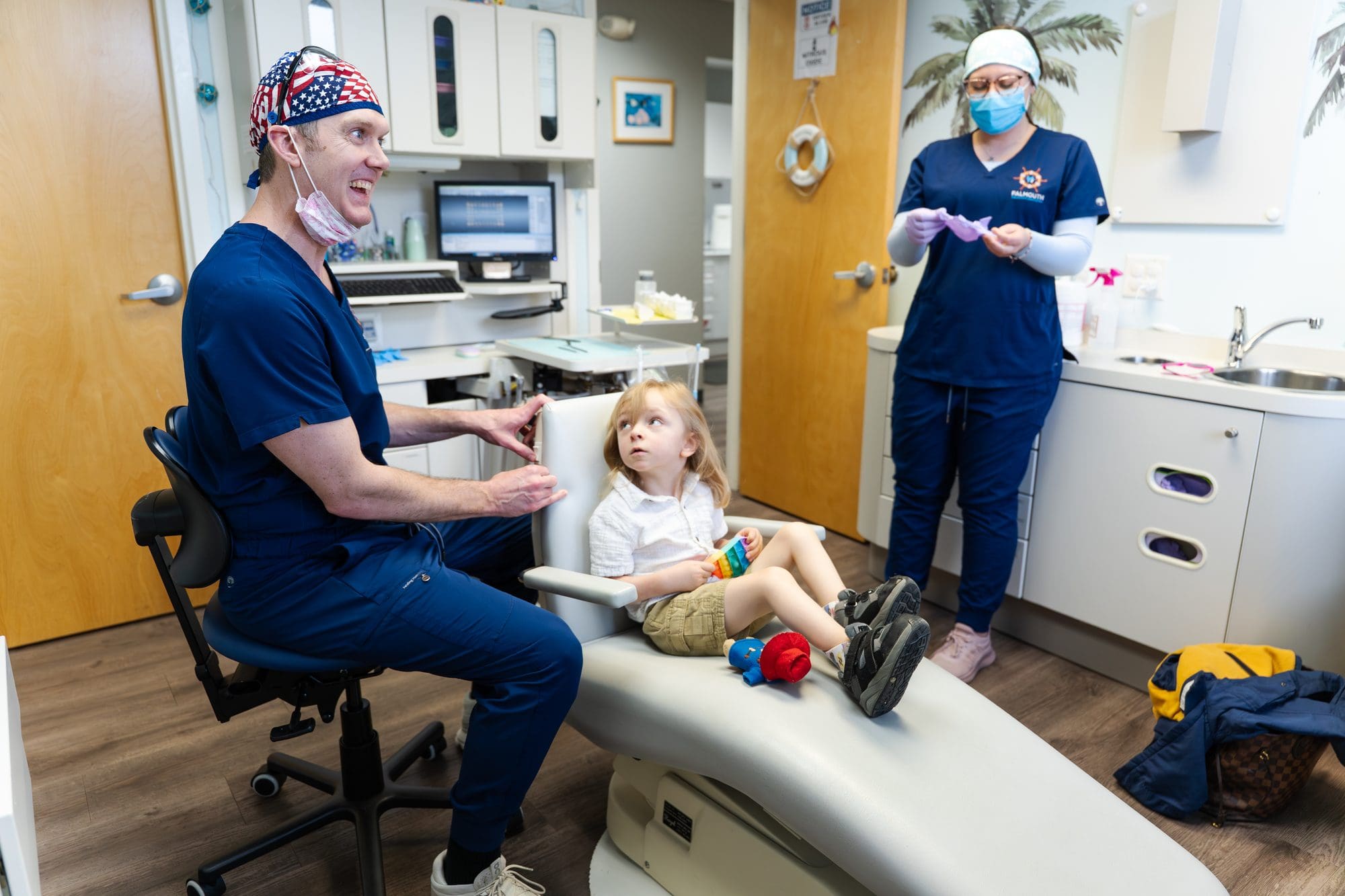 Dentist and assistant with child patient at Falmouth Pediatric Dentistry in Falmouth, ME