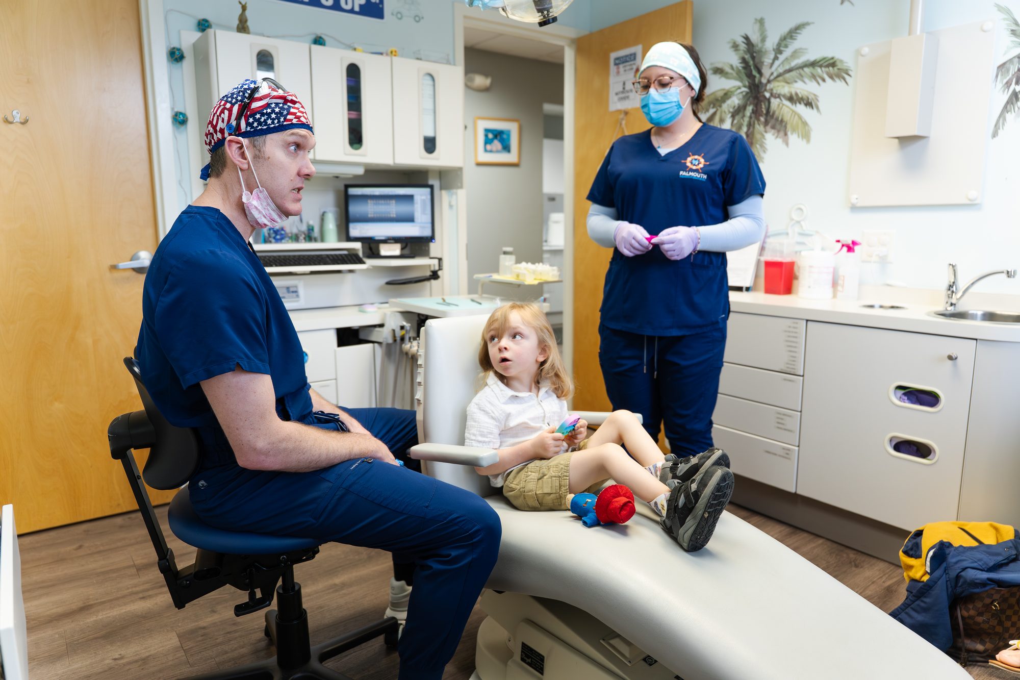 Dentist and assistant with child patient at Falmouth Pediatric Dentistry in Falmouth, ME