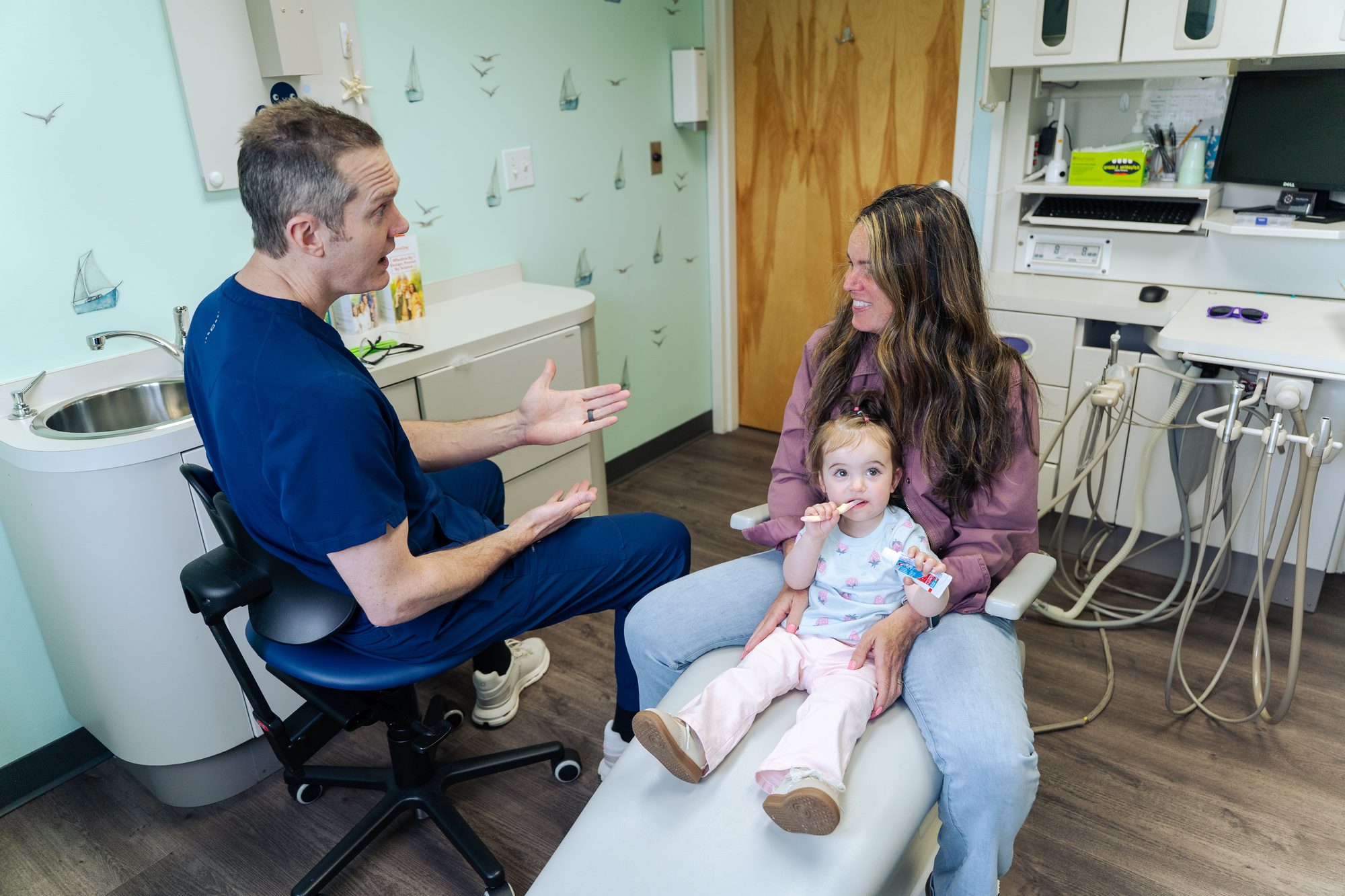 Falmouth Pediatric Dentistry ocean-themed waiting area with navy anchor rug and coastal decor in Falmouth, ME