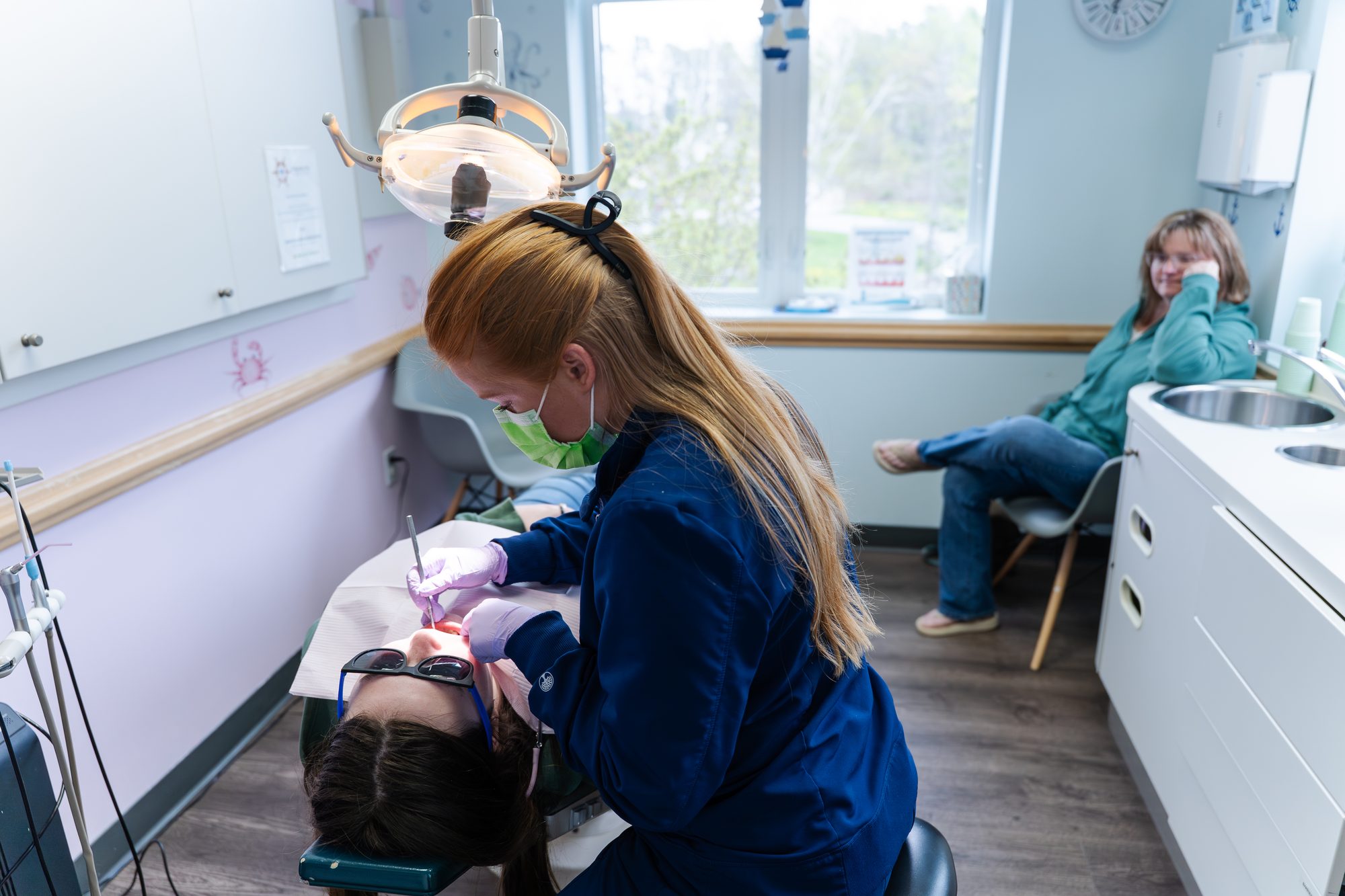 Dentist examining patient at Falmouth Pediatric Dentistry in Falmouth, ME